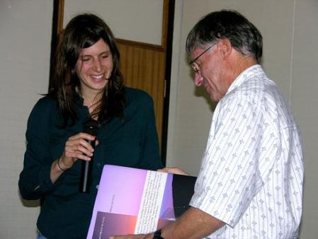 Dr. Nicole Tischler from the Foundación presents Dr. Darlix with a picture book describing Chilean National Parks.